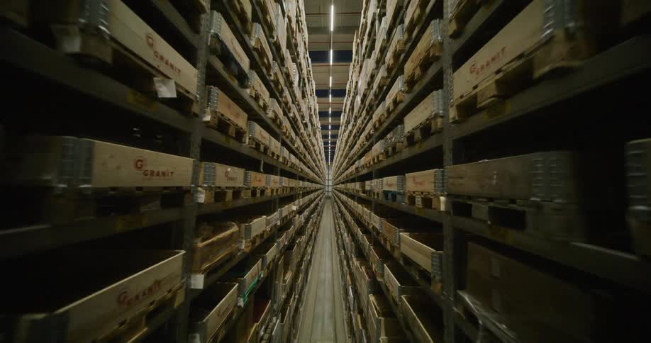 fpv drone flying through the aisles on a warehouse