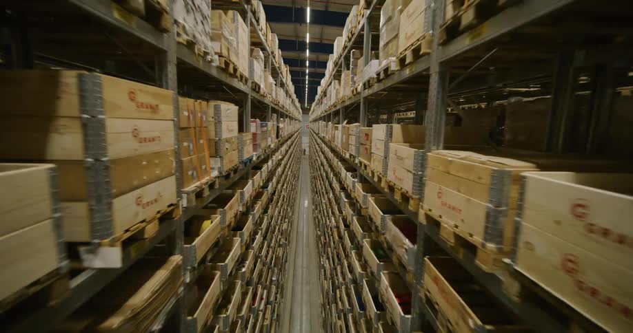 fpv drone flying through the aisles on a warehouse