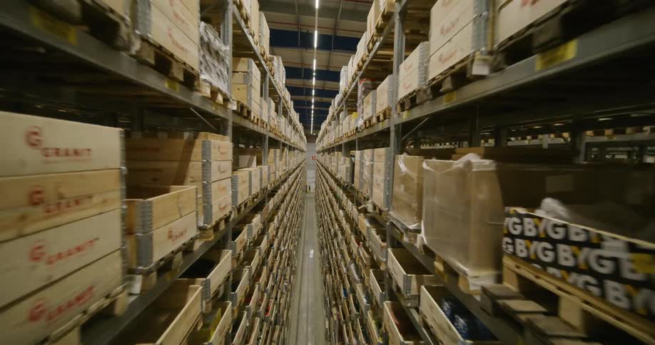 View from inside a logistics center with shelves and aisles filled with boxes