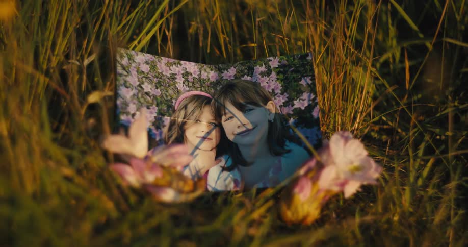Photo of two girls in the middle of a lawn