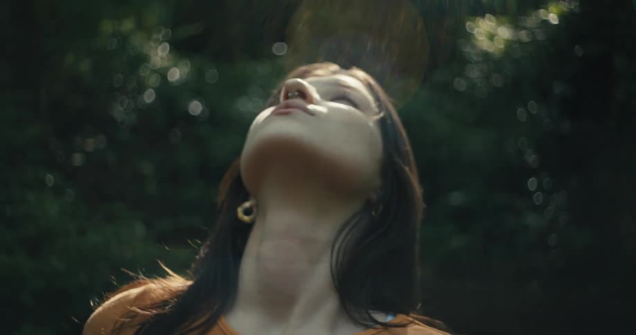 A woman looks around the forest