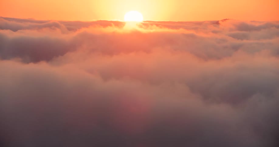 Aerial of the sunset behind the clouds