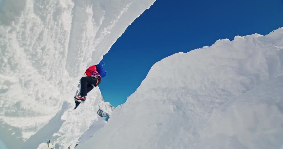 Mountaineer climbing an ice wall