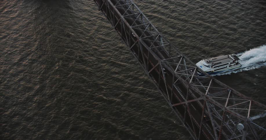 Aerial view of a ferry passing under the Richmond Bridge on the San Francisco Bay