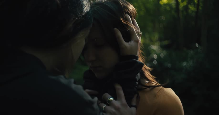 Two women hug in the forest