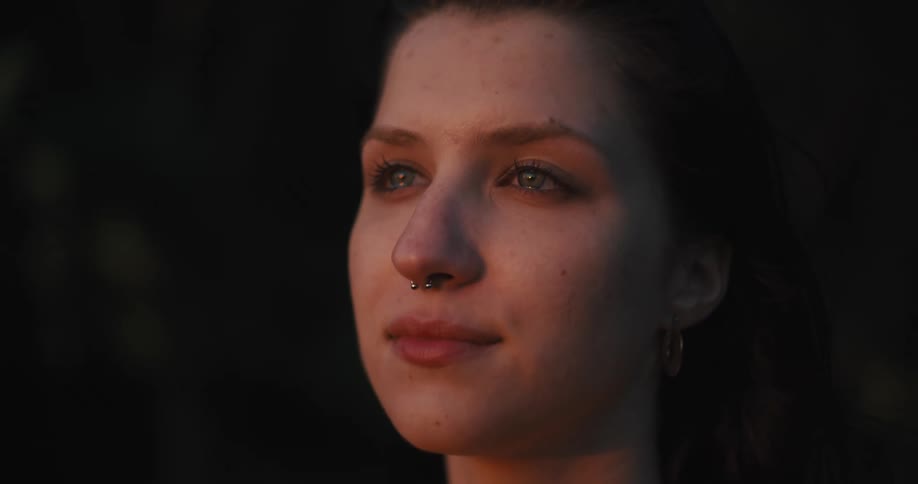 Happy woman cries while smiling looking at the sunset