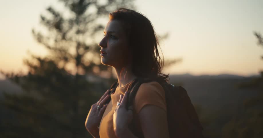Woman hiking on the mountains at sunset