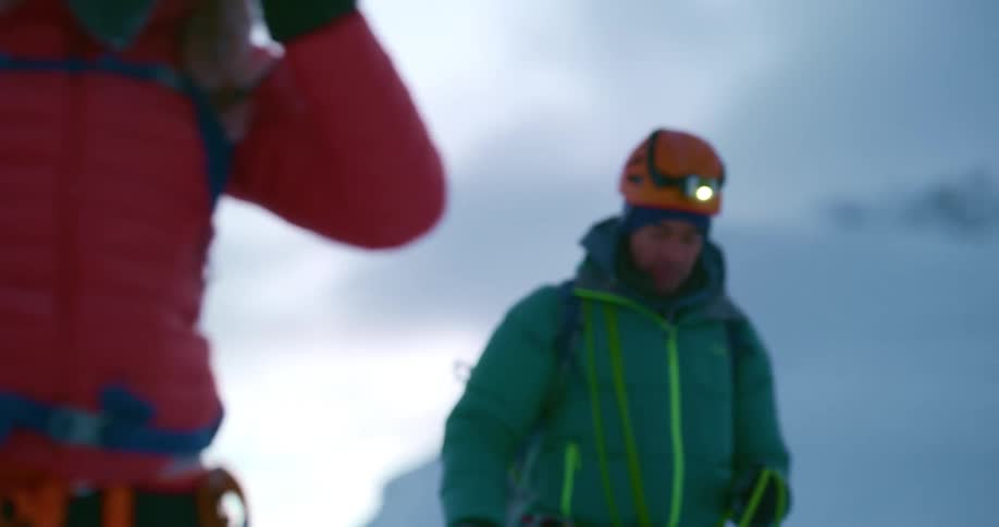Two mountaineers tied with security rope walking on the mountains