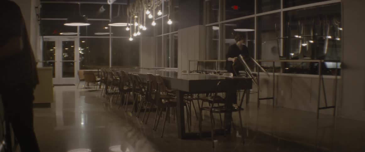 A coffee shop worker places chairs down