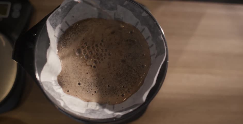 Hot water is poured over coffee grounds in a filter