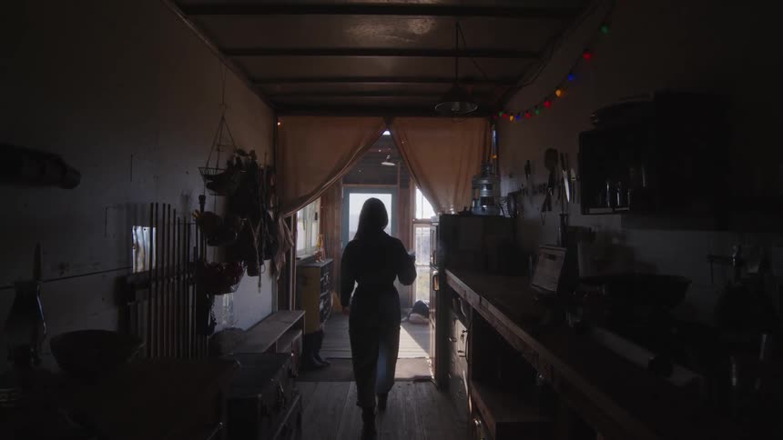 Silhouette of a woman burning incense at home