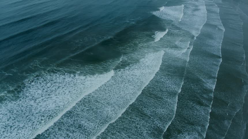 Many waves in a row on a beach