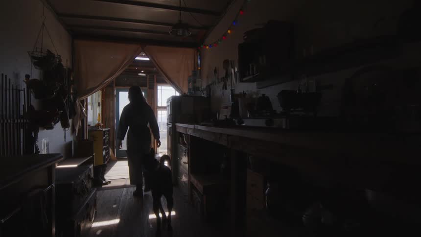 A woman walks out with her dog