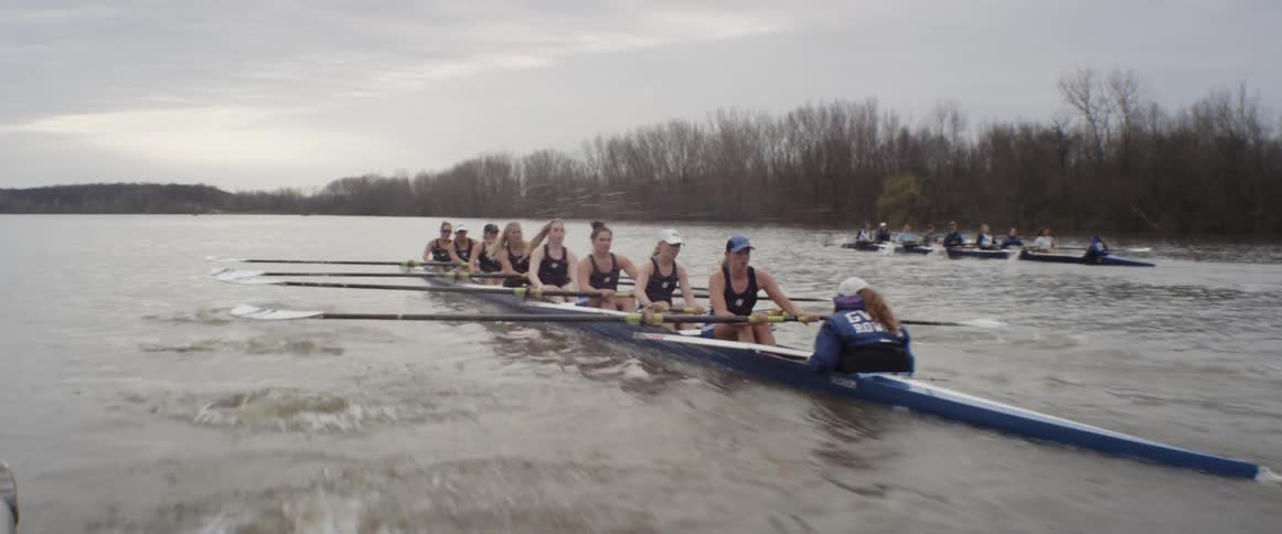 A female rowing team is competing