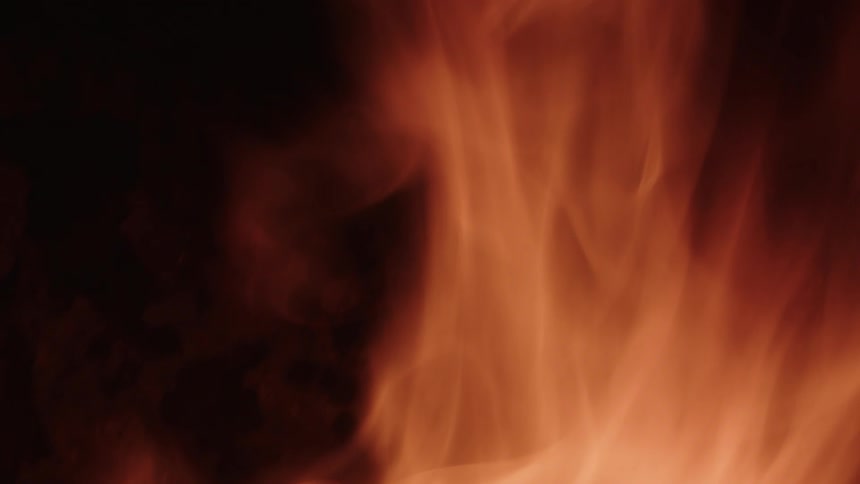 Close up of flames moving and wavering in the darkness