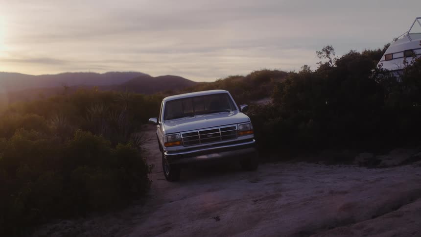 A truck is parked on the hill of the mountain