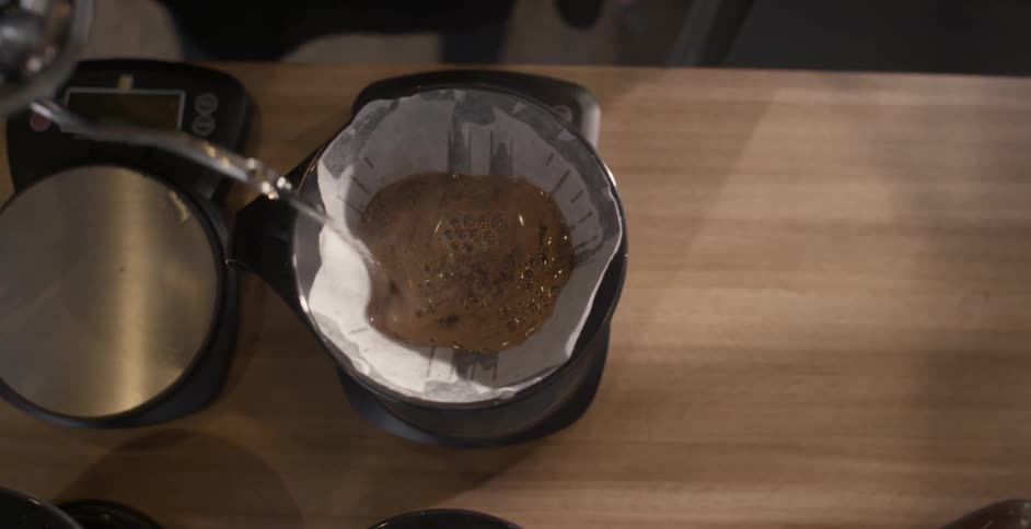 Water is poured over grounds in a coffee funnel