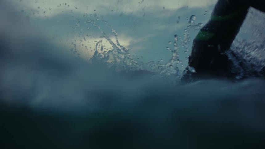 A man is swimming in the ocean