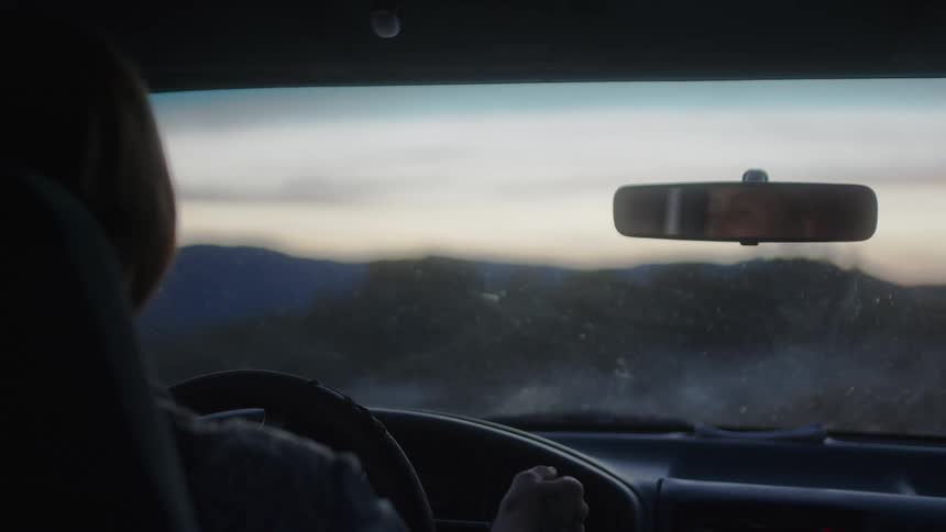 A woman puts the car into gear