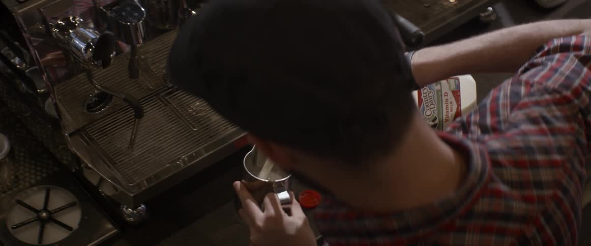 A man pours milk into a pitcher
