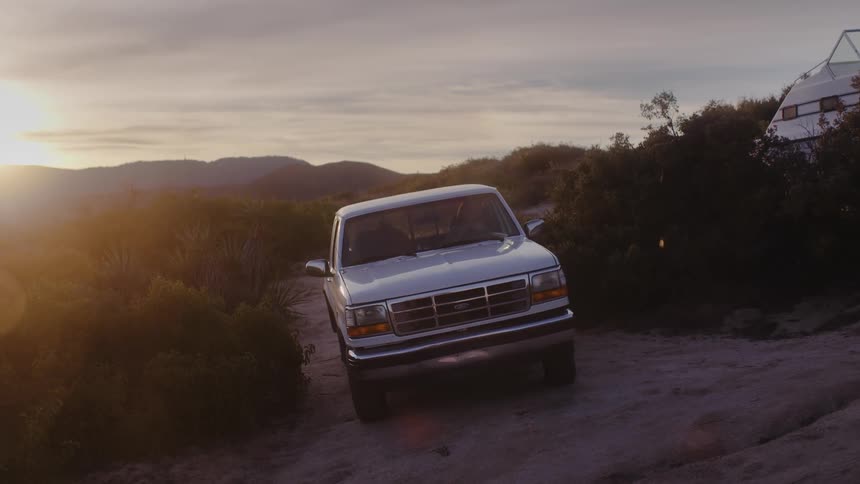 A truck drives uphill on the path