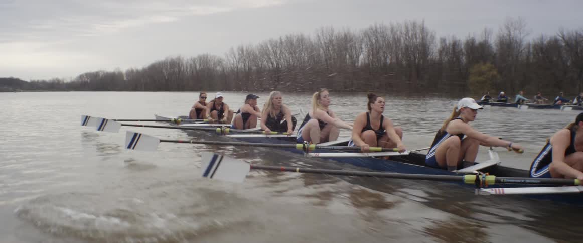 A team of female rowers are racing