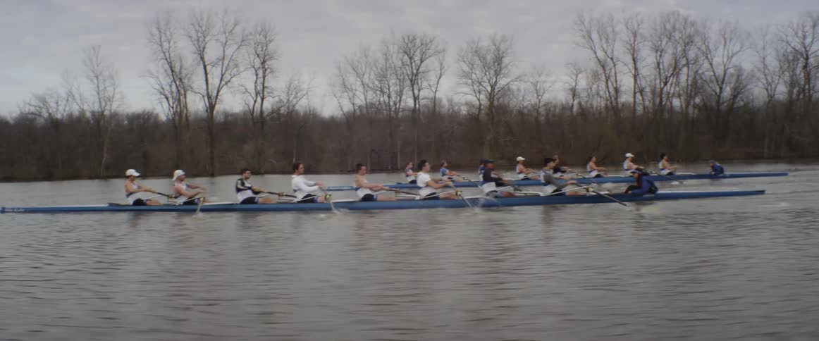 Rowboat teams propel themselves on a lake