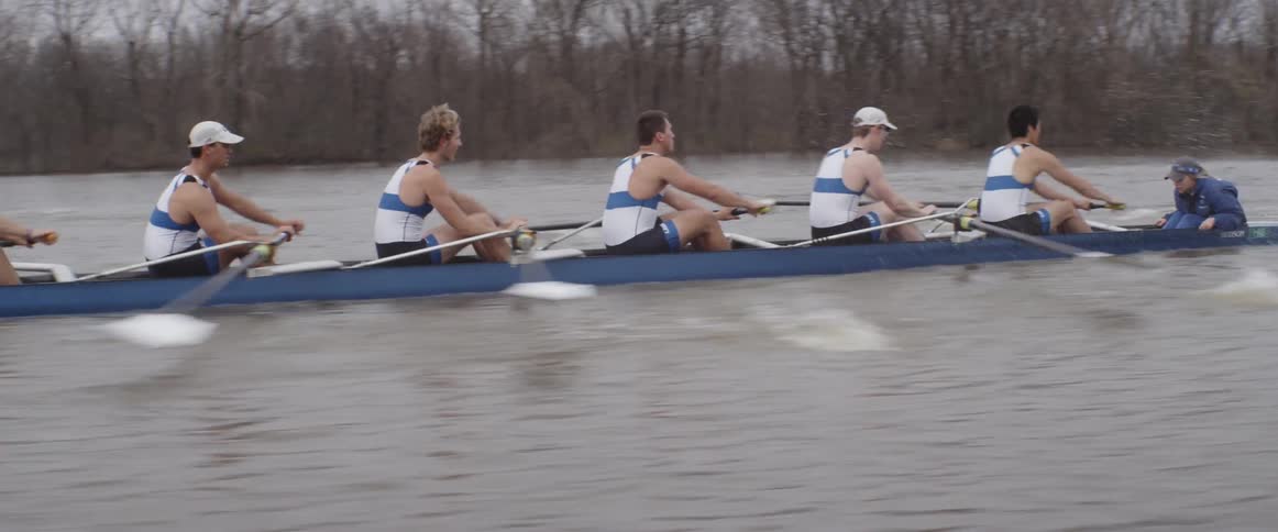 A team of male rowers are competing