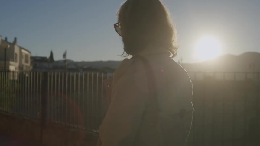 Woman walking on the neighborhood in the hills at morning