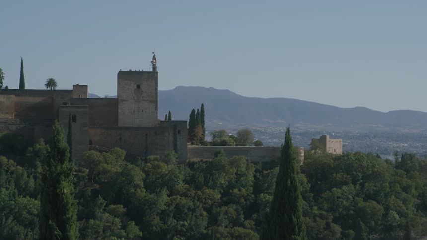 A historical building is shown popping out from behind a forest
