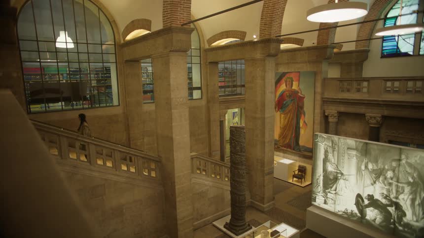 Woman climbing the stairs of an indoor museum inside a church