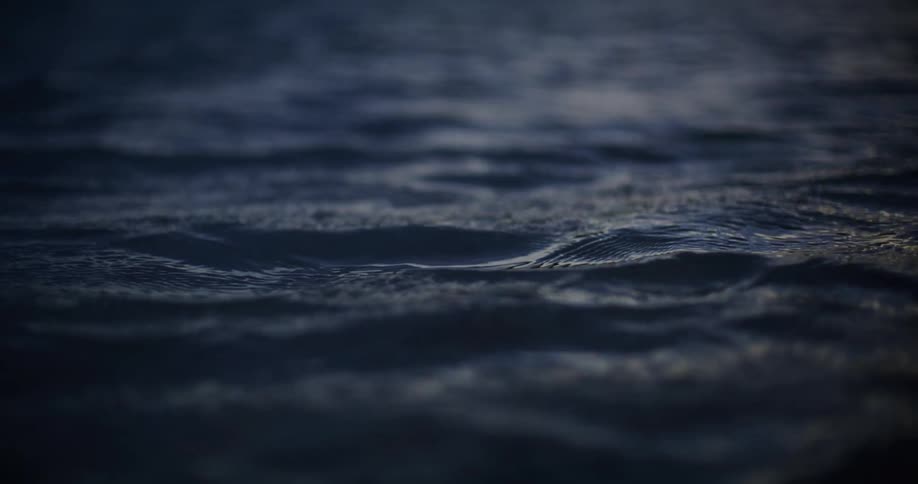 Light reflects on the water as it ripples and waves