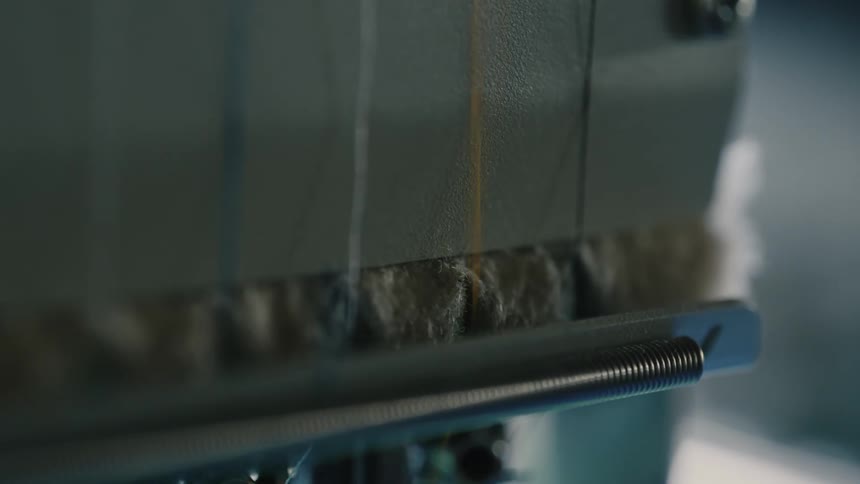 A small yellow thread is being pulled and scraping the surface that is