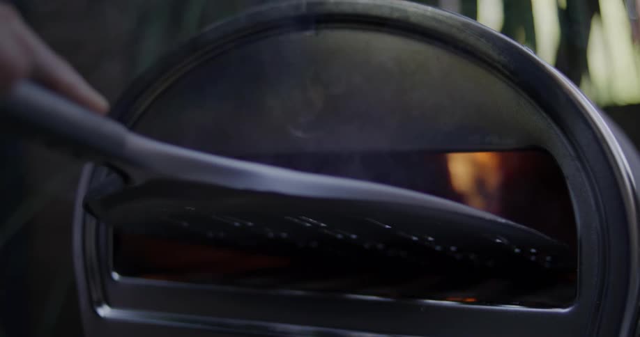 A person stirs the fire in the forge