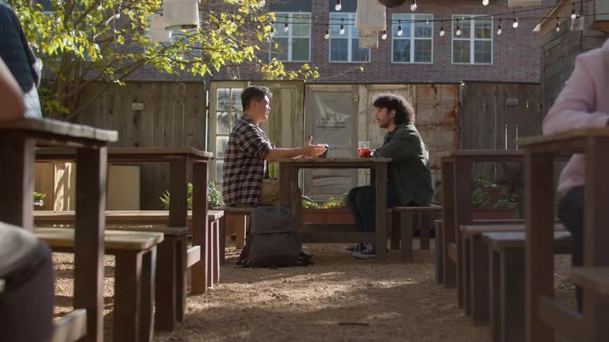 People are drinking tea and coffee outside of the restaurant