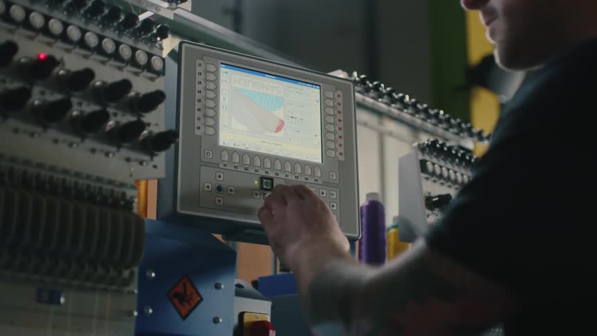 Worker operating an industrial sewing machine