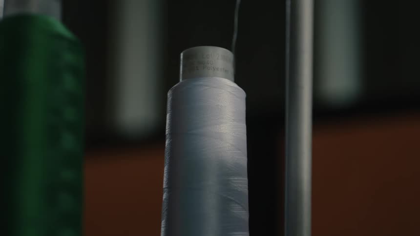 The thread unravels on the spool