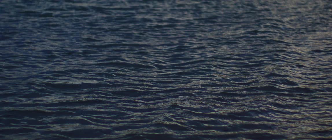 Sunlight reflects on the water as it ripples and waves