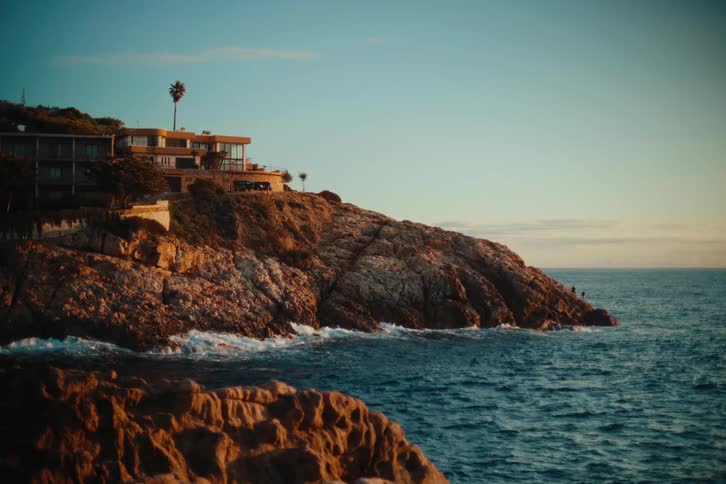 The mansion is on the rocks of the shore