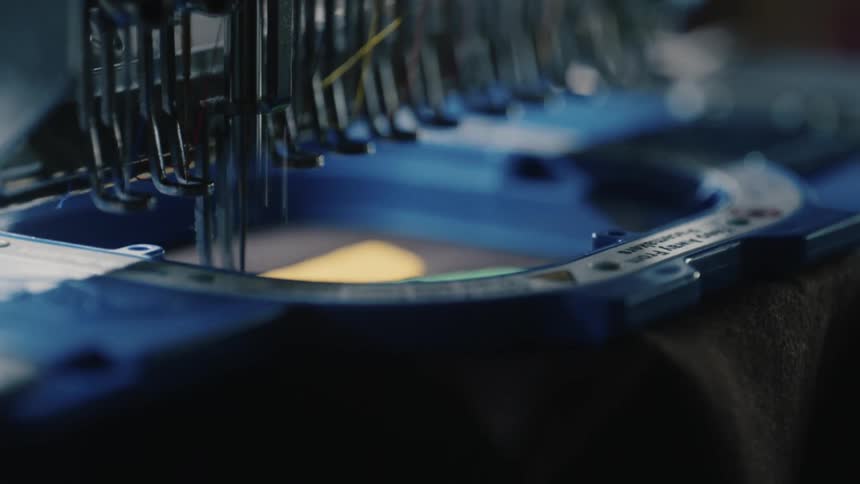 A sewing machine with a tool going up and down