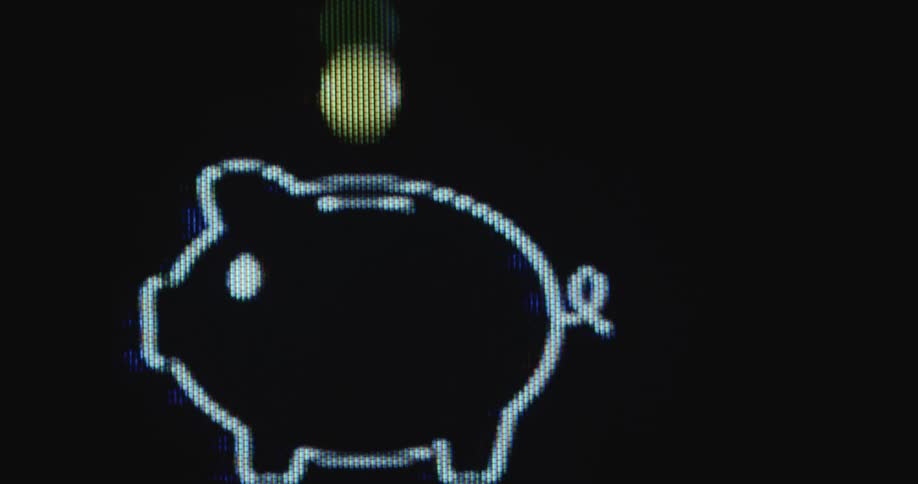 Extreme closeup of a digital screen with coins falling into a piggy bank icon as symbol for a savings account on an online banking platform or finance application