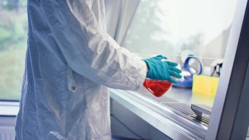 Technician disinfecting equipment in the laboratory