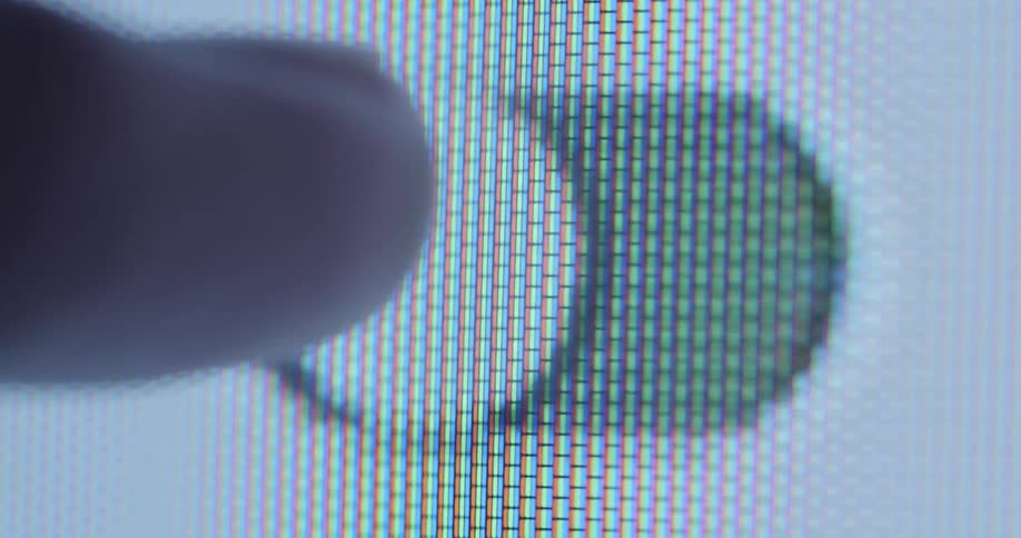 Finger moving a touch down responsive button on a screen with RGB pixel effect or structure switching between green on and white off setting while activating or deactivating a function