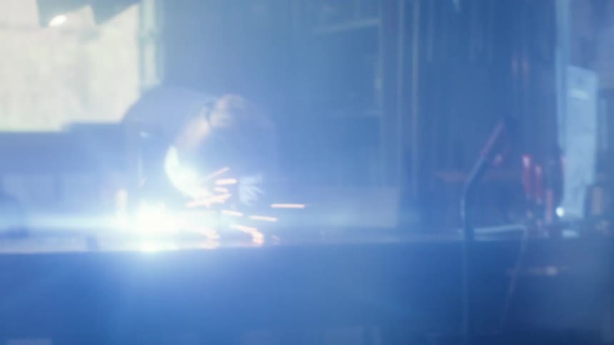 A man is welding in his shop