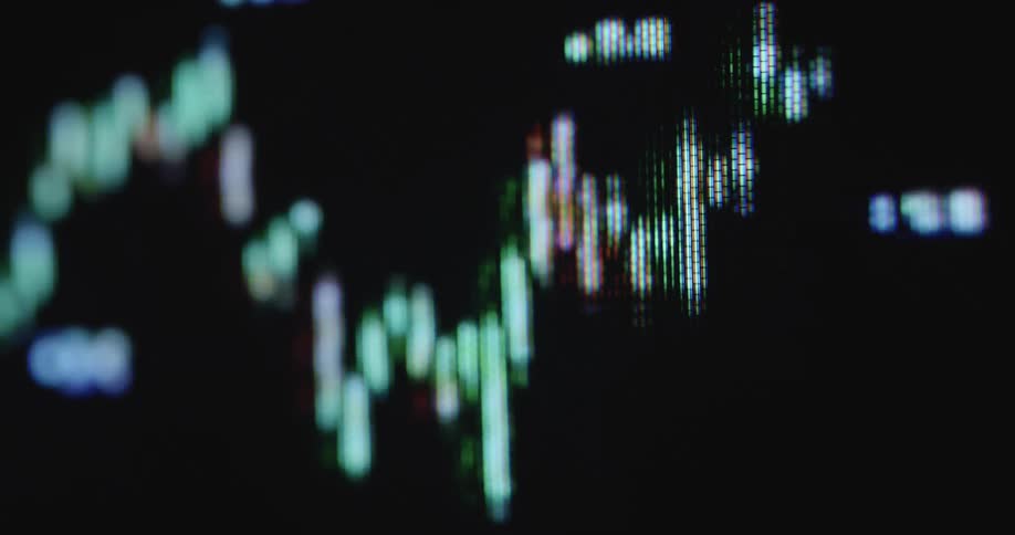 Extreme macro close up of a stock chart candle diagram with red and green candles and increasing and decreasing numbers on a dark digital computer screen with pixelated image and distortion