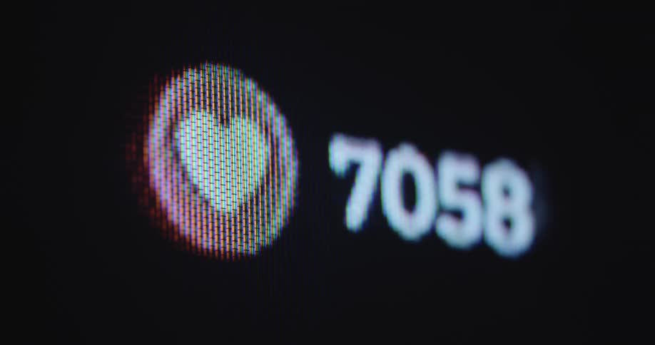 A pixelated retro television or computer screen showing a number rising quickly and a heart beating or pulsing next to it with fast speed symbolising increasing likes of a brand or company page on social media