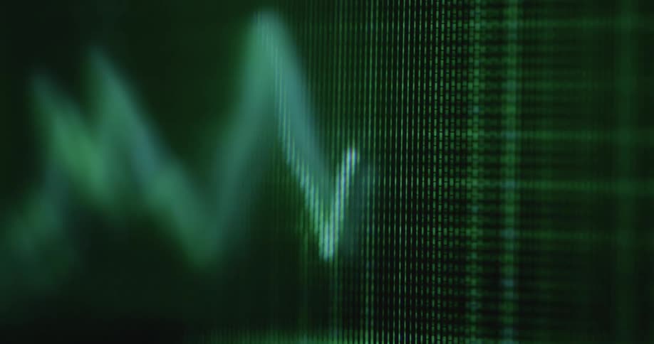Shaky hand-held extreme closeup with dynamic camera movement of green stock graph or trading chart on a moving screen with RGB pixels