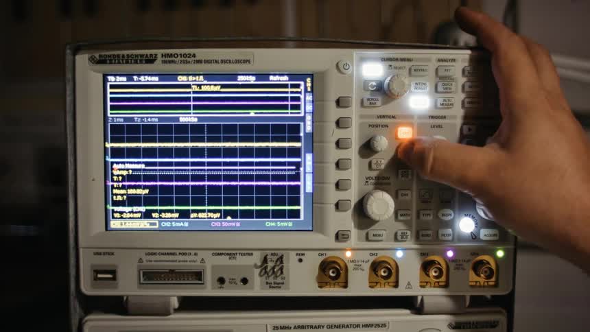 A person is pressing buttons on the medical device