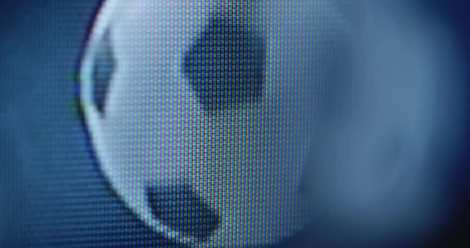 A digitized black and white retro soccer ball rolls spins or flies on a pixelated computer screen as it warps and fades while symbolising the world cup or European championship