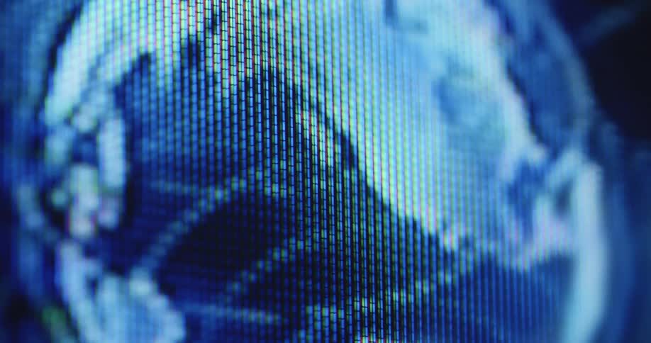 Extreme macro closeup of a screen with RGB pixels displaying a spinning or rotating globe or planet of the earth showing the continents of Europe and America and the entire world